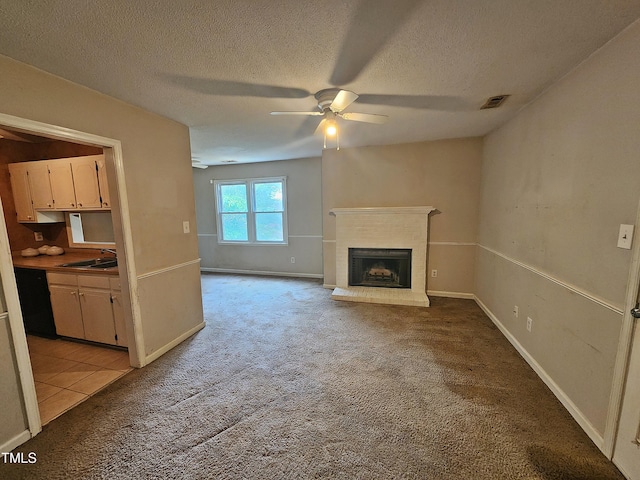 3559 Mill Run, Raleigh, NC 27612 - unfurnished living room with light carpet, ceiling fan, a sink, a fireplace, and a textured ceiling