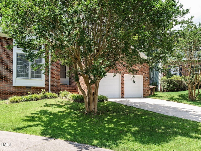 108 S Drawbridge Ln, Cary, NC 27513 - view of property hidden behind natural elements featuring concrete driveway, a front yard, and brick siding