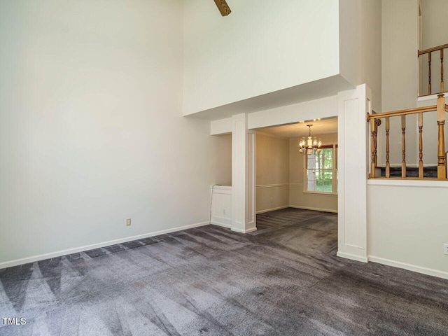 108 S Drawbridge Ln, Cary, NC 27513 - unfurnished living room with carpet floors, a high ceiling, and a chandelier