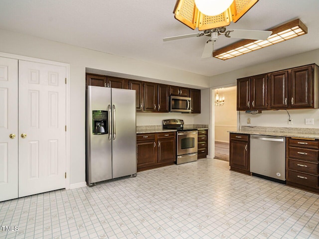 108 S Drawbridge Ln, Cary, NC 27513 - kitchen with stainless steel appliances, dark brown cabinetry, ceiling fan, and light stone counters