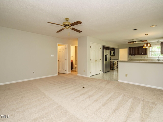 108 S Drawbridge Ln, Cary, NC 27513 - unfurnished living room with a ceiling fan, light colored carpet, and a textured ceiling