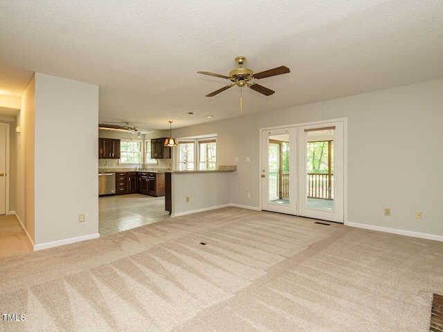 108 S Drawbridge Ln, Cary, NC 27513 - unfurnished living room featuring ceiling fan, light colored carpet, and a textured ceiling