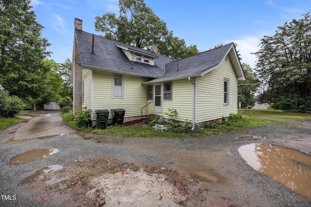 421 E Morehead St, Burlington, NC 27215 - rear view of house featuring a chimney and roof with shingles
