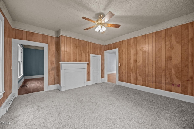 421 E Morehead St, Burlington, NC 27215 - unfurnished bedroom with carpet, a textured ceiling, wooden walls, baseboard heating, and ceiling fan