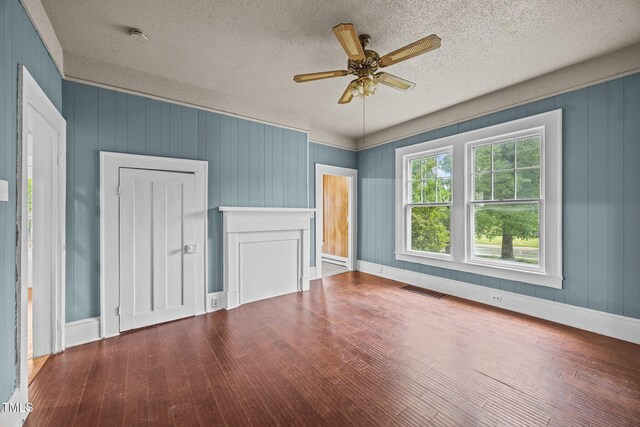 421 E Morehead St, Burlington, NC 27215 - unfurnished bedroom with wood finished floors, a textured ceiling, baseboards, and a ceiling fan