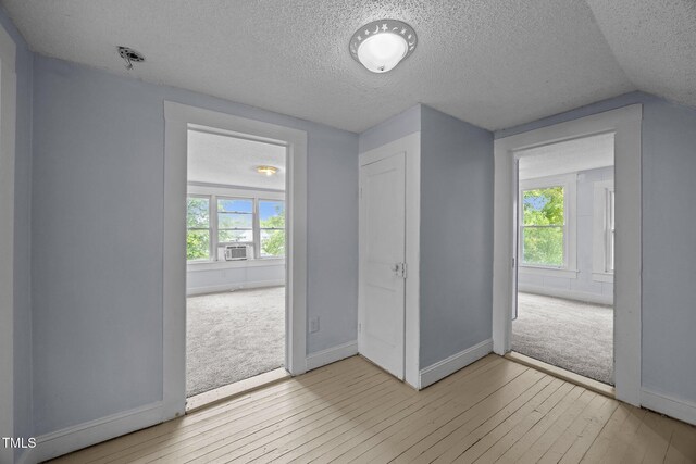 421 E Morehead St, Burlington, NC 27215 - interior space featuring a textured ceiling, baseboards, multiple windows, and light carpet