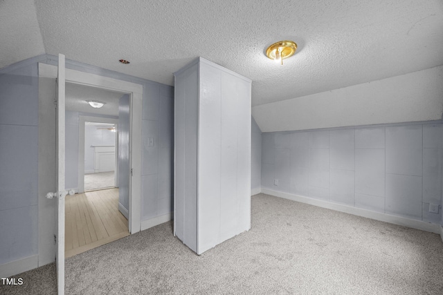 421 E Morehead St, Burlington, NC 27215 - additional living space featuring a textured ceiling, carpet flooring, lofted ceiling, and baseboards