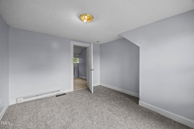 421 E Morehead St, Burlington, NC 27215 - unfurnished bedroom with baseboard heating, a textured ceiling, carpet, and baseboards