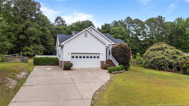 6301 Mockingbird Ln, Sanford, NC 27332 - view of home's exterior featuring driveway, a garage, and brick siding
