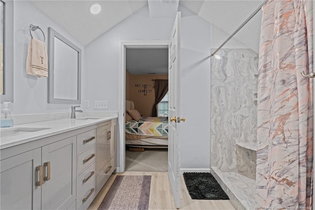 6301 Mockingbird Ln, Sanford, NC 27332 - bathroom featuring a marble finish shower, lofted ceiling, double vanity, ensuite bath, and wood finished floors