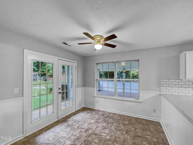1216 Briarwood Dr, Mebane, NC 27302 - spare room with french doors, ceiling fan, a textured ceiling, and tile patterned floors
