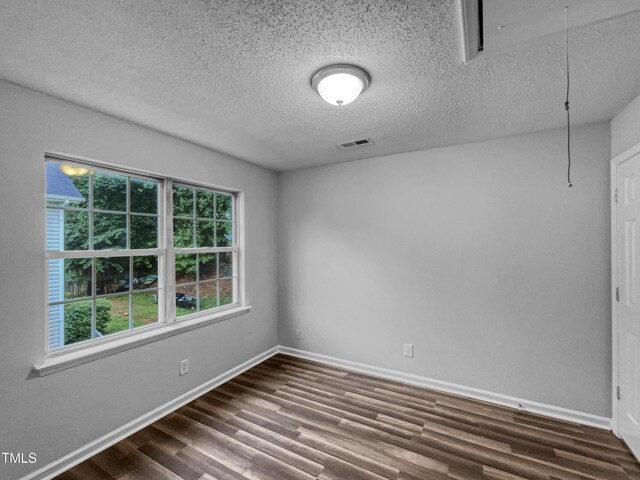 1216 Briarwood Dr, Mebane, NC 27302 - unfurnished room featuring attic access, dark wood finished floors, baseboards, and a textured ceiling