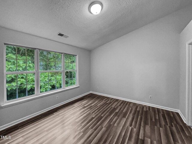 1216 Briarwood Dr, Mebane, NC 27302 - spare room featuring dark wood-type flooring, baseboards, and a textured ceiling