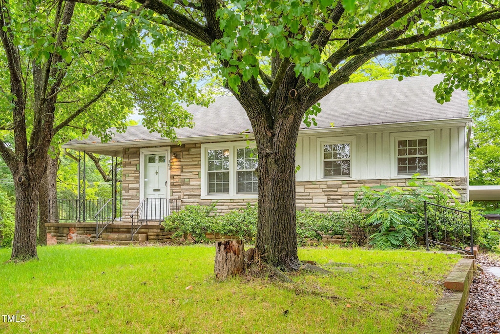504 Delaware Ave, Burlington, NC 27217 - view of front of house featuring stone siding, board and batten siding, a front yard, and a shingled roof