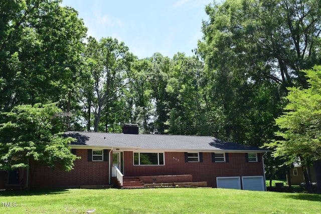 515 Wildwood Dr, Durham, NC 27712 - single story home with a garage, a chimney, a front yard, and brick siding