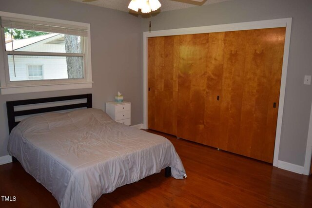 515 Wildwood Dr, Durham, NC 27712 - bedroom with a closet, wood finished floors, and baseboards