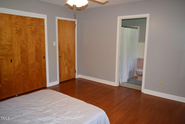 515 Wildwood Dr, Durham, NC 27712 - bedroom featuring wood finished floors, multiple closets, connected bathroom, baseboards, and ceiling fan