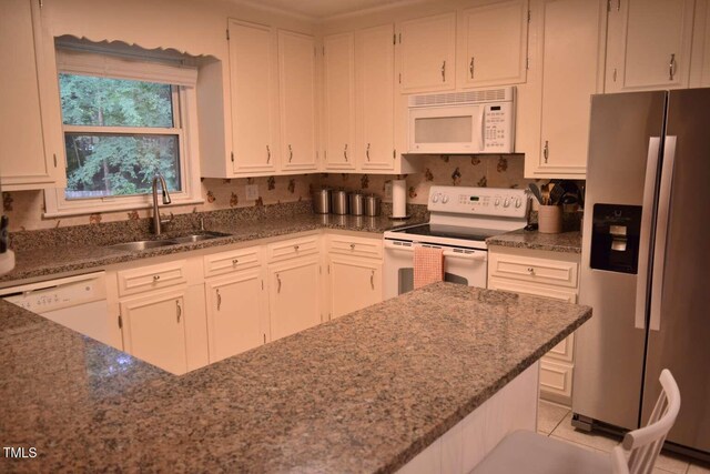 515 Wildwood Dr, Durham, NC 27712 - kitchen featuring white appliances, a sink, dark stone counters, and white cabinetry