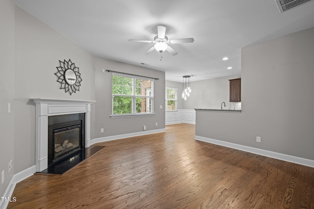 238 Langford Valley Way, Cary, NC 27513 - unfurnished living room featuring ceiling fan, a glass covered fireplace, recessed lighting, wood finished floors, and baseboards