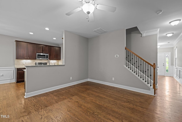 238 Langford Valley Way, Cary, NC 27513 - unfurnished living room featuring ornamental molding, dark wood-style flooring, stairs, a ceiling fan, and recessed lighting