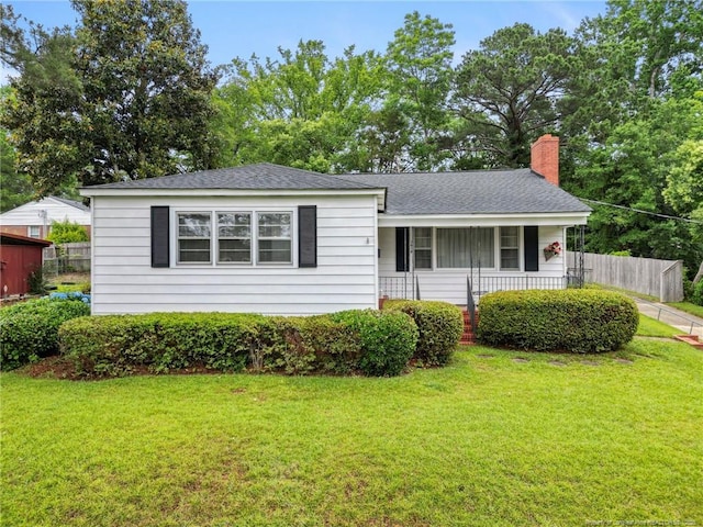 1918 Rogers Dr, Fayetteville, NC 28303 - view of front of home with a chimney, roof with shingles, and covered porch