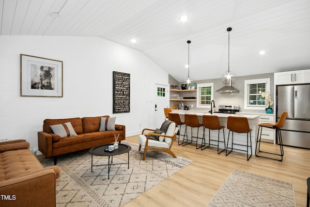 117 Bertie Dr, Raleigh, NC 27610 - living area featuring lofted ceiling, light wood finished floors, recessed lighting, and baseboards