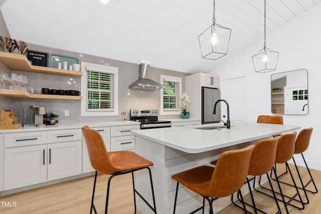 117 Bertie Dr, Raleigh, NC 27610 - kitchen with wall chimney exhaust hood, electric stove, a sink, freestanding refrigerator, and white cabinets