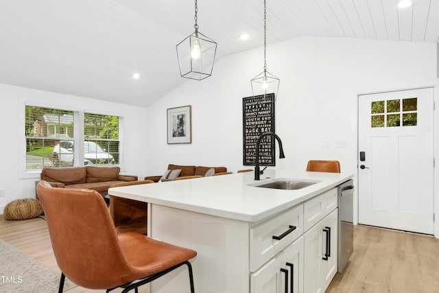 117 Bertie Dr, Raleigh, NC 27610 - kitchen featuring a sink, lofted ceiling, light wood-style floors, light countertops, and hanging light fixtures