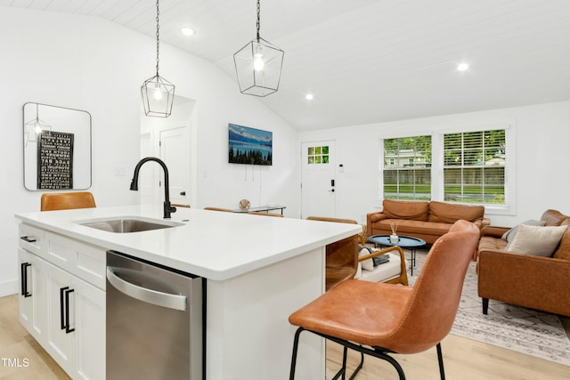 117 Bertie Dr, Raleigh, NC 27610 - kitchen with a sink, stainless steel dishwasher, lofted ceiling, open floor plan, and light wood-style flooring