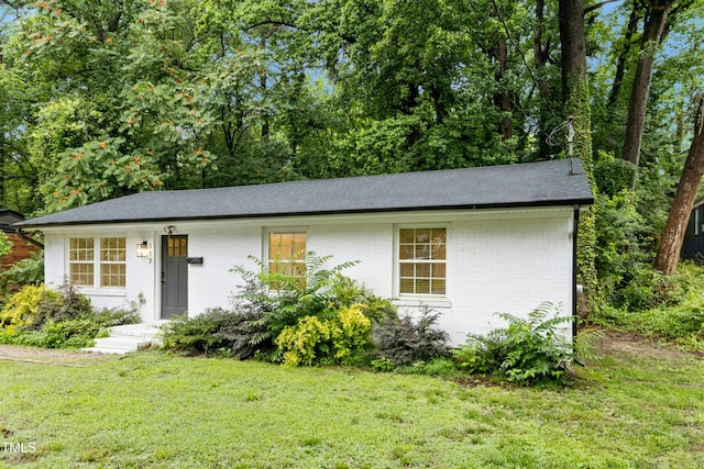 117 Bertie Dr, Raleigh, NC 27610 - view of front of property with brick siding, a front lawn, and roof with shingles