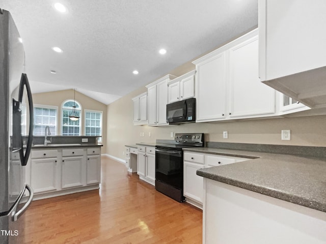 1005 Augustine Trl, Cary, NC 27518 - kitchen featuring black appliances, dark countertops, light wood-style flooring, white cabinetry, and recessed lighting