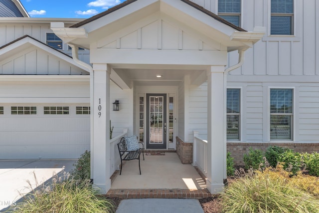 109 Crested Coral Dr, Holly Springs, NC 27540 - property entrance featuring board and batten siding, a garage, covered porch, and concrete driveway