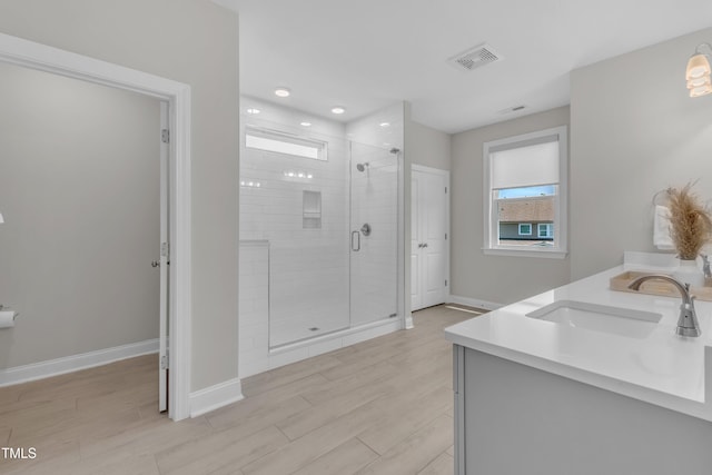 109 Crested Coral Dr, Holly Springs, NC 27540 - full bath featuring a shower stall, double vanity, wood finished floors, and baseboards