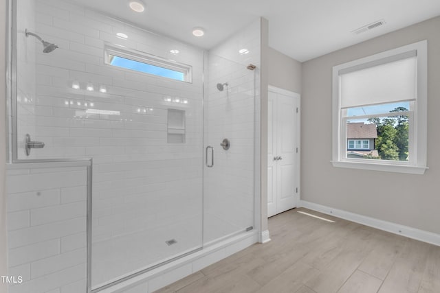 109 Crested Coral Dr, Holly Springs, NC 27540 - bathroom featuring a stall shower, plenty of natural light, wood finished floors, and baseboards