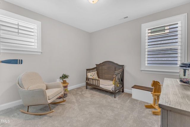 109 Crested Coral Dr, Holly Springs, NC 27540 - carpeted bedroom with multiple windows, baseboards, and a nursery area