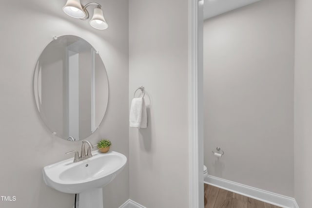 109 Crested Coral Dr, Holly Springs, NC 27540 - bathroom featuring baseboards, a sink, toilet, and wood finished floors