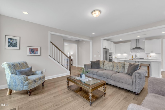 109 Crested Coral Dr, Holly Springs, NC 27540 - living area featuring light wood-style floors, stairs, baseboards, and recessed lighting