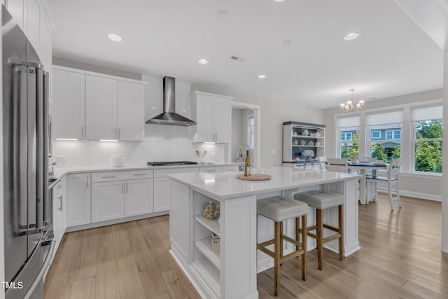 109 Crested Coral Dr, Holly Springs, NC 27540 - kitchen with wall chimney exhaust hood, high end refrigerator, gas cooktop, open shelves, and white cabinetry