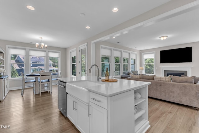 109 Crested Coral Dr, Holly Springs, NC 27540 - kitchen featuring a sink, open shelves, a chandelier, light countertops, and white cabinetry