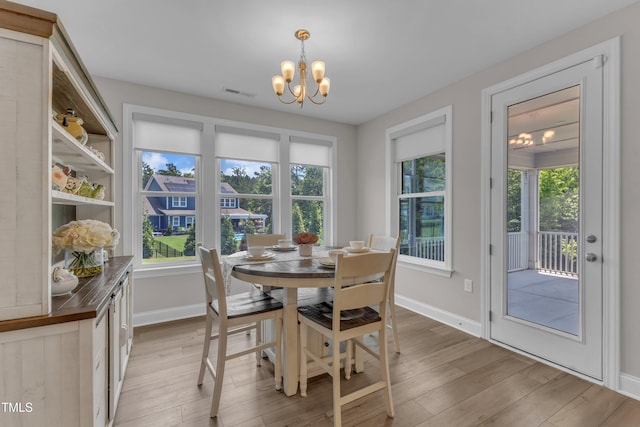 109 Crested Coral Dr, Holly Springs, NC 27540 - dining area with a chandelier, light wood-style floors, and baseboards