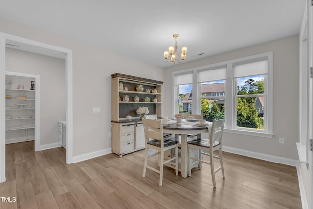 109 Crested Coral Dr, Holly Springs, NC 27540 - dining space with a chandelier, light wood-style floors, and baseboards