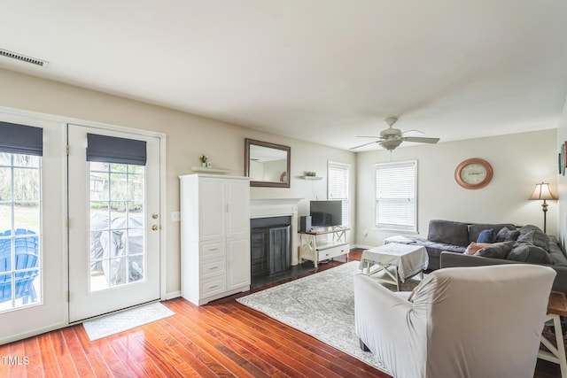 6 Newgate Ct, Durham, NC 27713 - living area featuring ceiling fan, wood finished floors, a fireplace with flush hearth, and baseboards