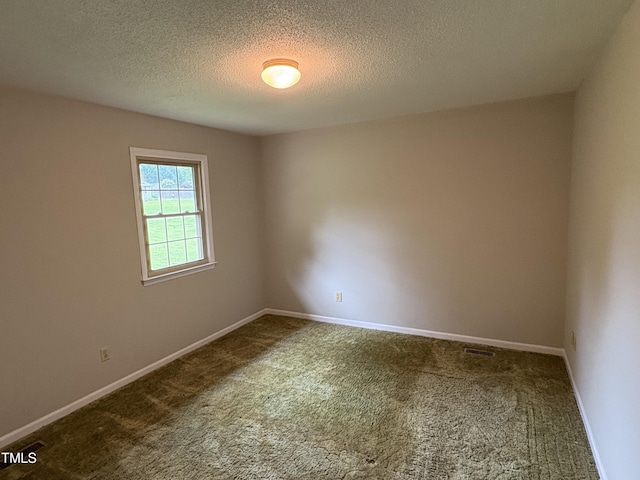 1942 Brier Ln, Graham, NC 27253 - empty room featuring dark carpet, baseboards, and a textured ceiling
