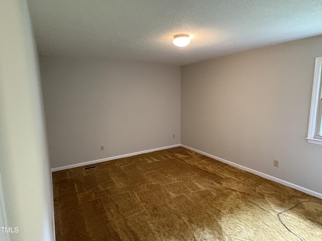 1942 Brier Ln, Graham, NC 27253 - unfurnished room featuring dark colored carpet, a textured ceiling, and baseboards