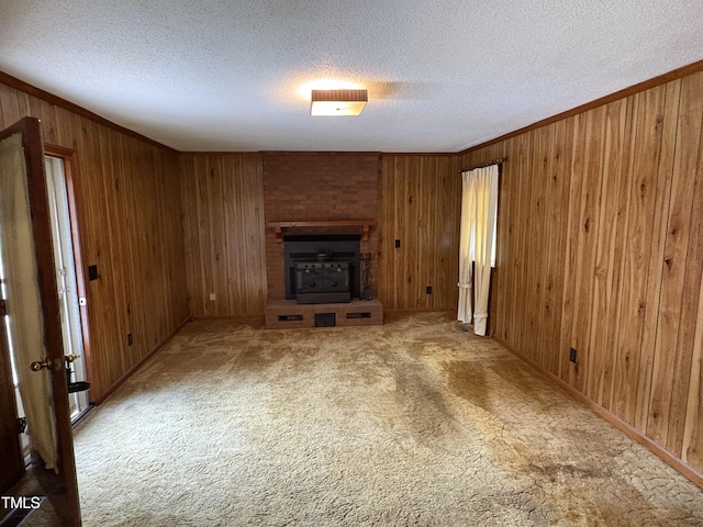 1942 Brier Ln, Graham, NC 27253 - unfurnished living room featuring wood walls, a textured ceiling, carpet flooring, and ornamental molding