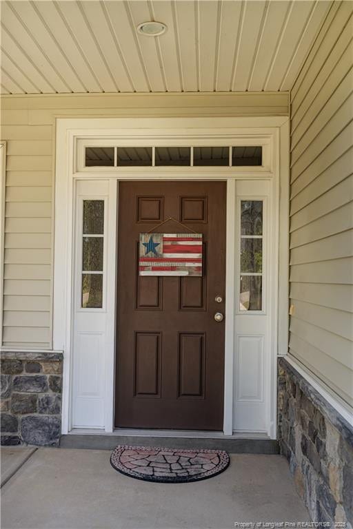 101 Birdsong Ct, Aberdeen, NC 28315 - view of exterior entry featuring stone siding