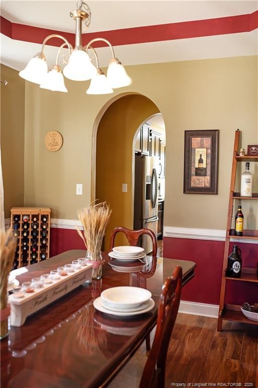 101 Birdsong Ct, Aberdeen, NC 28315 - dining room with arched walkways, dark wood-type flooring, and baseboards
