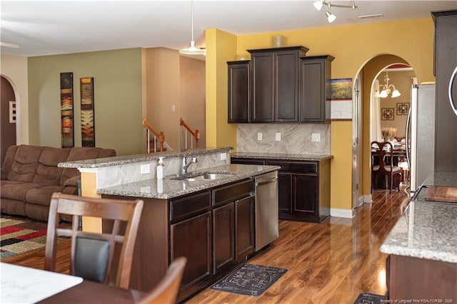 101 Birdsong Ct, Aberdeen, NC 28315 - kitchen featuring arched walkways, a sink, appliances with stainless steel finishes, open floor plan, and wood finished floors