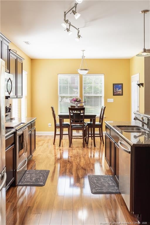 101 Birdsong Ct, Aberdeen, NC 28315 - kitchen featuring a sink, appliances with stainless steel finishes, decorative light fixtures, and light wood finished floors