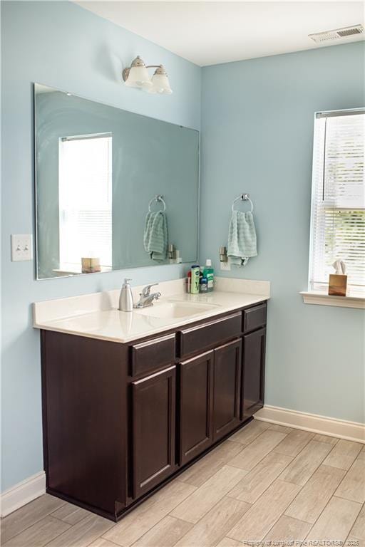 101 Birdsong Ct, Aberdeen, NC 28315 - bathroom with vanity, wood finish floors, and healthy amount of natural light